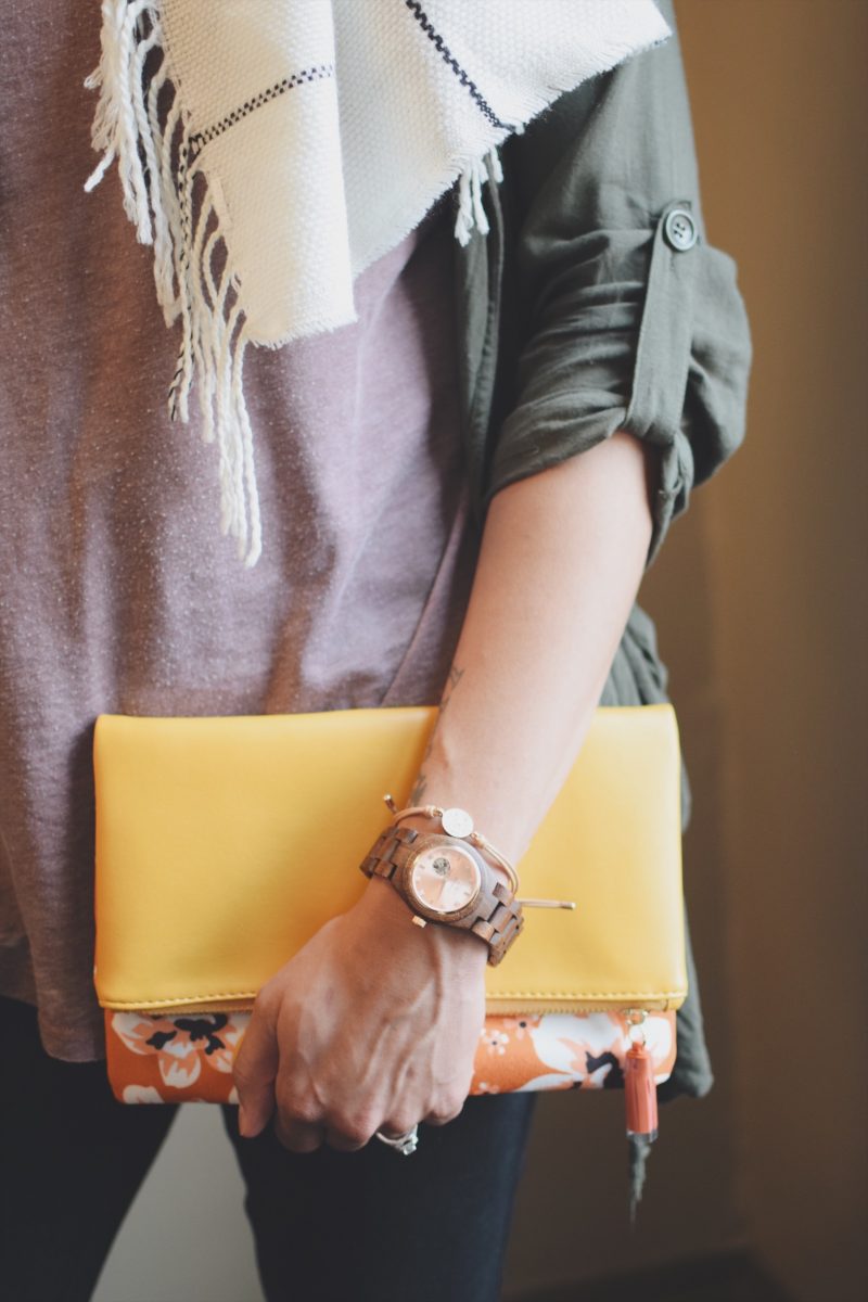 wooden watch with yellow clutch bag