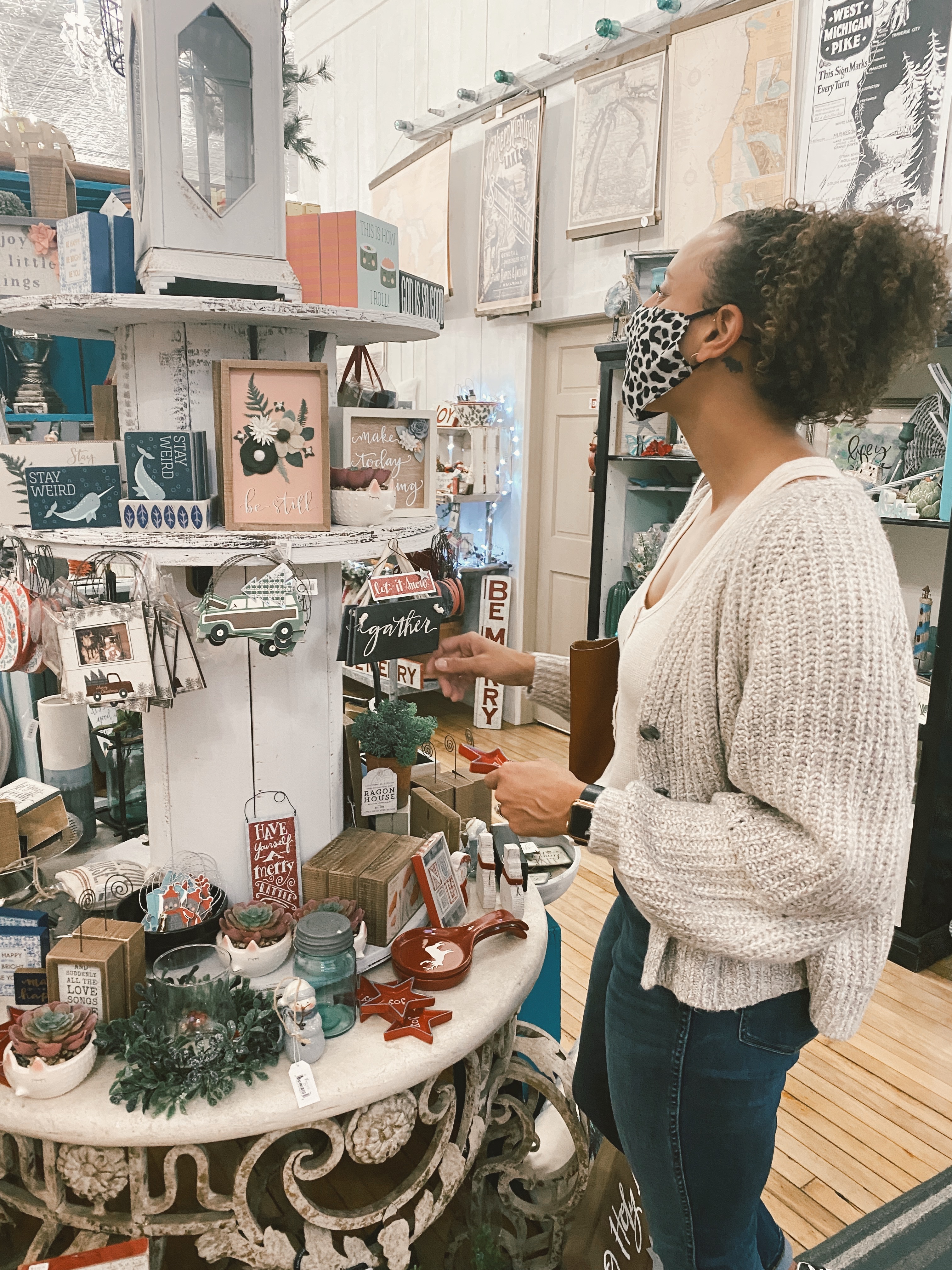 mixed race woman wearing a mask in a store while shopping